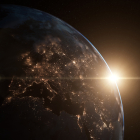 Representación de un amanecer visto desde el espacio, con el Sol asomándose detrás de la Tierra.